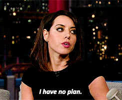 An attractive brunette white woman (Aubrey Plaza) glances sideways while saying, "I have no plan."
