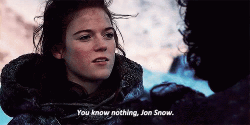 An attractive redheaded white woman with rosy cheeks and a fur hood says, "You know nothing, Jon Snow."