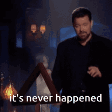 A heavy-set bearded man sweeps a hand and says "It's never happened"