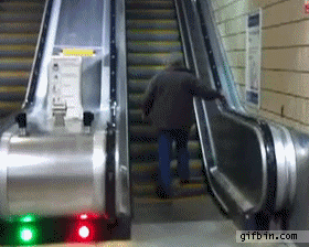 A man tries to climb up a down escalator.
