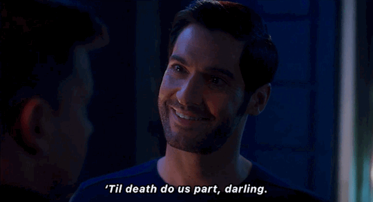 Tom Ellis as Lucifer smiles at Caine while saying "'Til death do us part, darling."