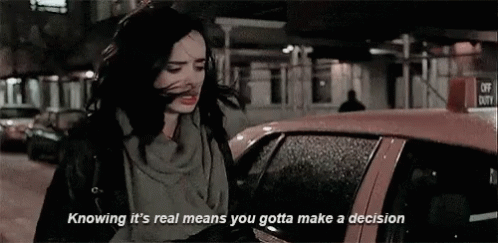 Krysten Ritter as Jessica Jones says, "Knowing it's real means you gotta make a decision."