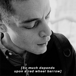 Mr. Robot looks thoughtful as a voiceover says "So much depends upon a red wheel barrow"