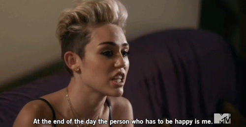 A beautiful femme person with a blond undercut pompadour (Miley Cyrus) says "At the end of the day the person who has to be happy is me."